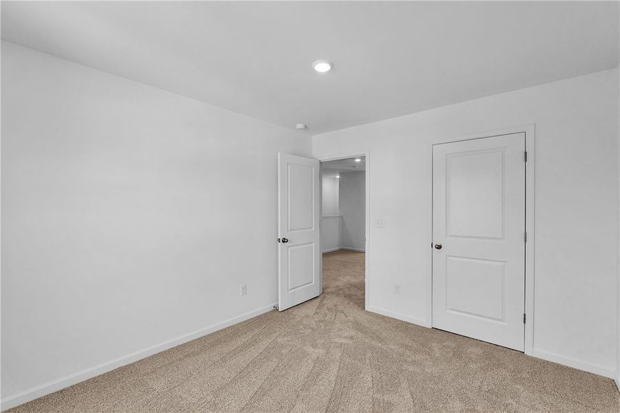 This spacious bedroom offers comfortable carpet fl This spacious bedroom offers comfortable carpet fl