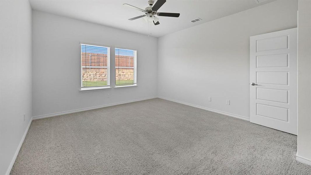 Spare room with light carpet and ceiling fan