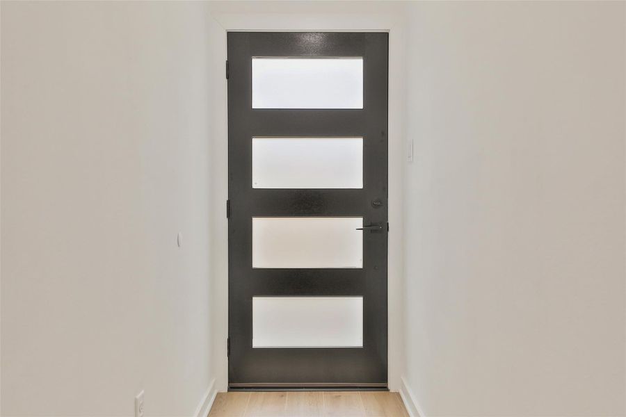 Welcome guests with a chic, modern five-panel front door. Welcome guests with a chic, modern five-panel front door.