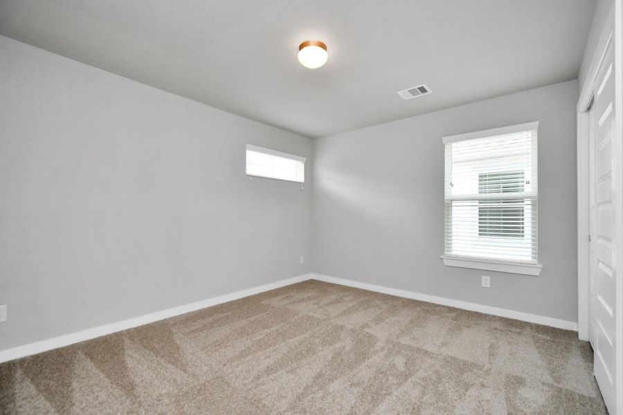 Discover another view of the secondary bedrooms! Sample photo of completed home with similar floor plan. Actual colors and selections may vary.