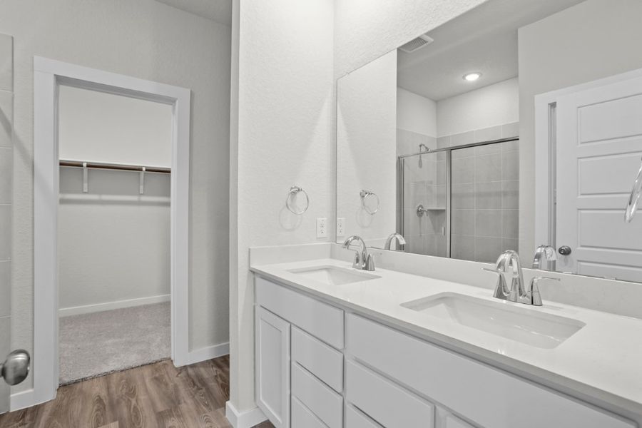A bathroom with a large mirror.