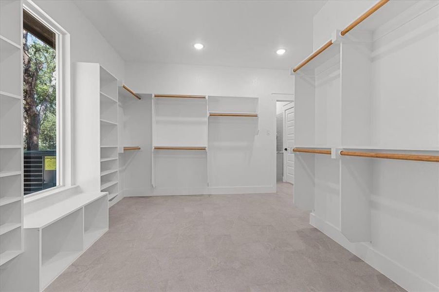 View of spacious  primary walk-in closet