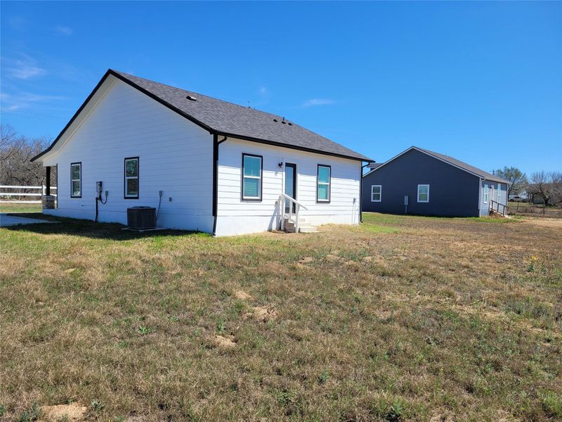 Well-maintained structures stand against a clear sky on a sprawling lot, presenting an ideal rural setting. Well-maintained structures stand against a clear sky on a sprawling lot, presenting an ideal rural setting.