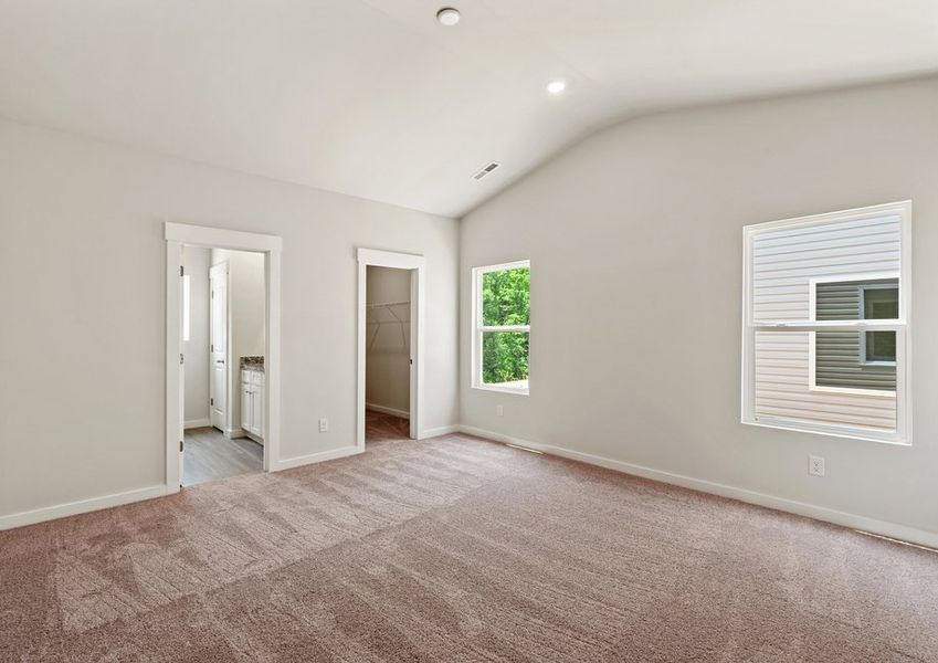 The master bedroom has lots of windows to let in natural light
