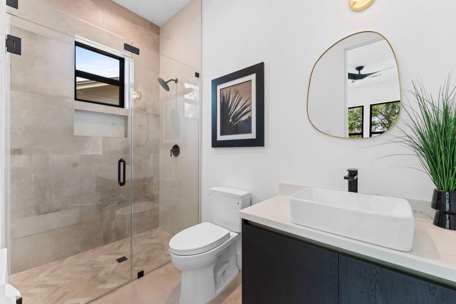 Custom tilework, floating vanity, and walk-in shower bring hotel-level comfort home.