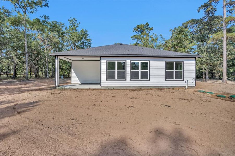 A view of the back of the house. This is roughly the amount of property that will have grass laid prior to closing. You will have approx. 30 feet of grass in the back and approx. 8 feet off each side of the house with a sprinkler system for the grassed areas.