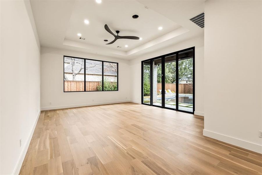 The main floor bedroom/game room opens directly to the backyard, creating an easy indoor outdoor flow that works just as well for everyday hangouts as it does for entertaining