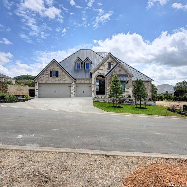 Front exterior of a new home in The Dominion, San Antonio, TX, highlighting curb appeal (Image 1). Front exterior of a new home in The Dominion, San Antonio, TX, highlighting curb appeal (Image 1).