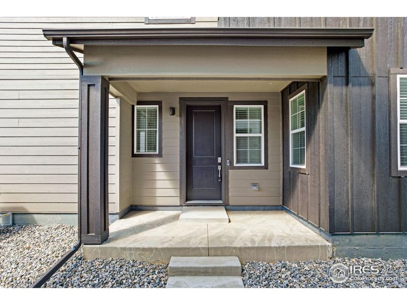 Front exterior of a new home in Westside Crossing Townhomes, Berthoud, CO, highlighting curb appeal (Image 21).