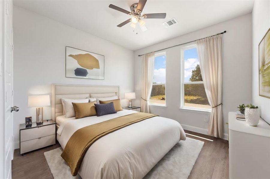 Bedroom with ceiling fan, hardwood / wood-style flooring, and multiple windows