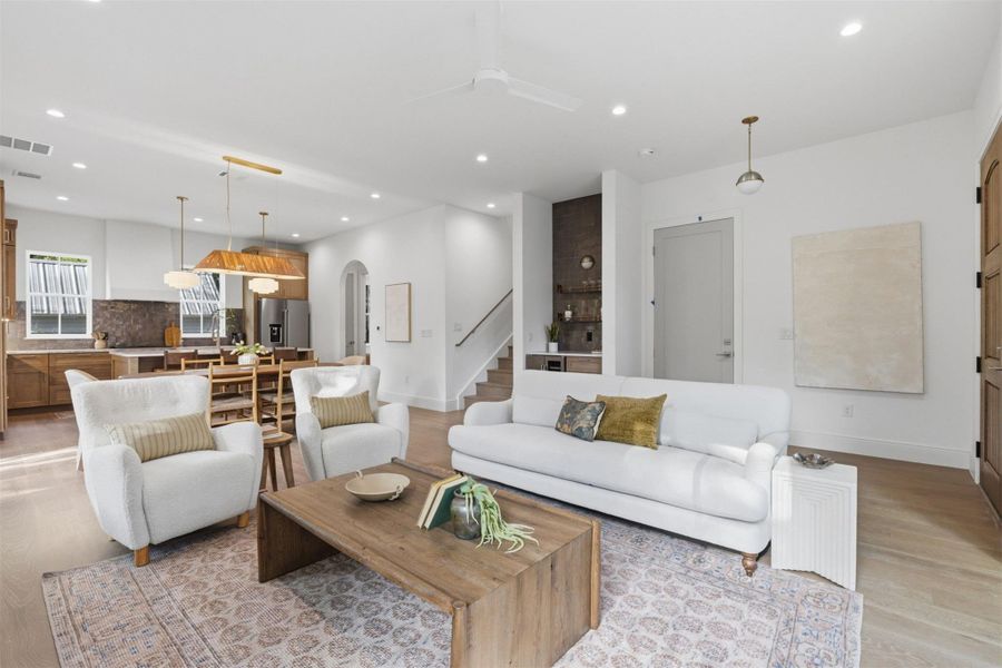 An open-concept living space integrates a well-appointed kitchen and dining area with a comfortable living room.