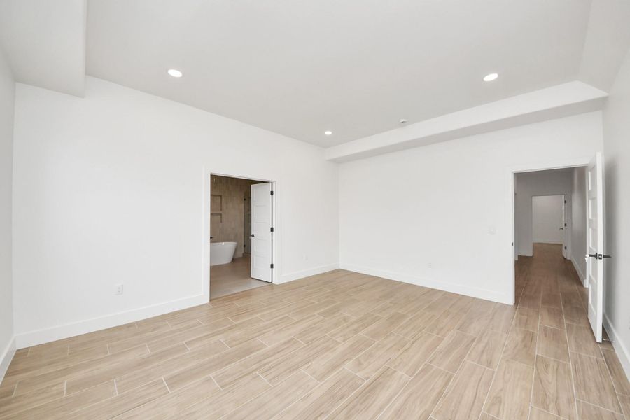 Wood like tile floors throughout the entire home. First Primary Bedroom