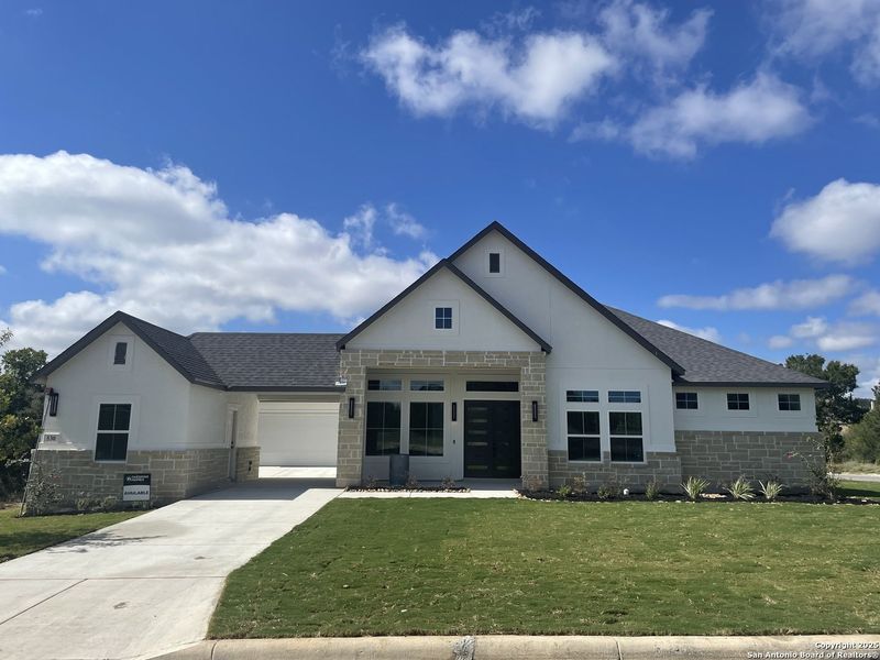 Front exterior of a new home in Potranco Oaks, Castroville, TX, highlighting curb appeal (Image 1). Front exterior of a new home in Potranco Oaks, Castroville, TX, highlighting curb appeal (Image 1).