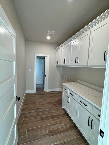 Laundry room with cabinets, hookup for a washing machine, and dark hardwood / wood-style flooring