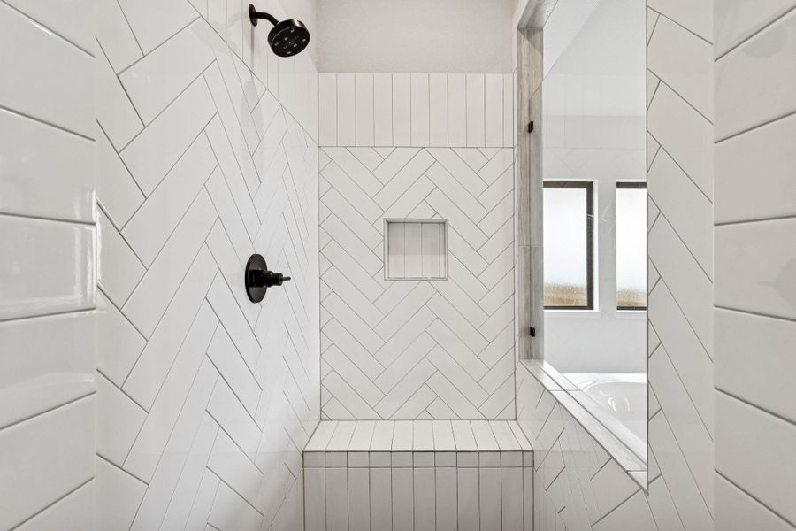 fully tiled walk-in shower in primary bathroom