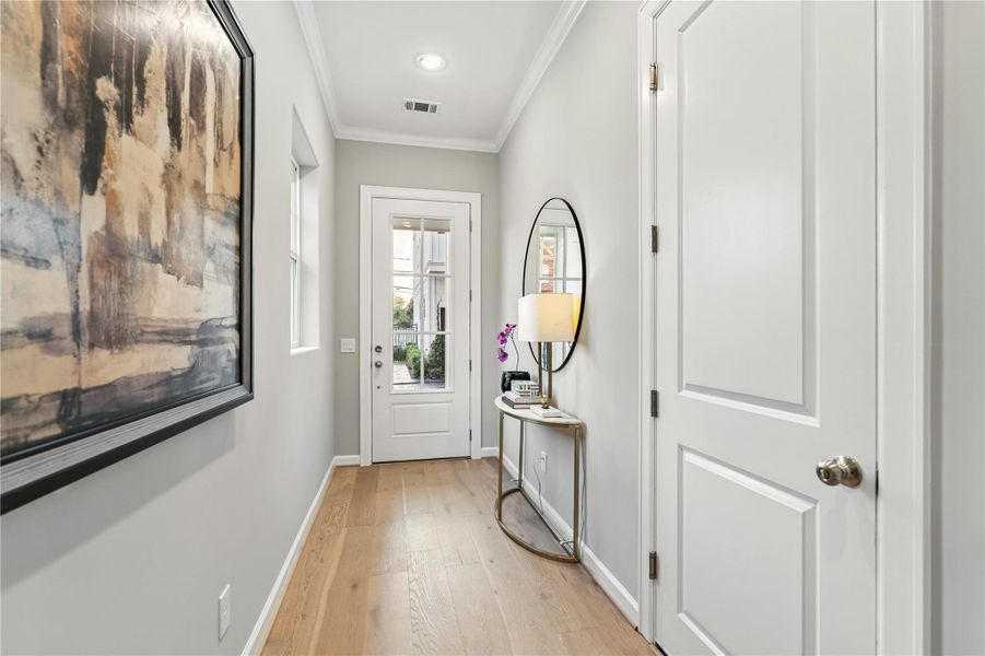 Beautiful foyer with oak colored hardwood