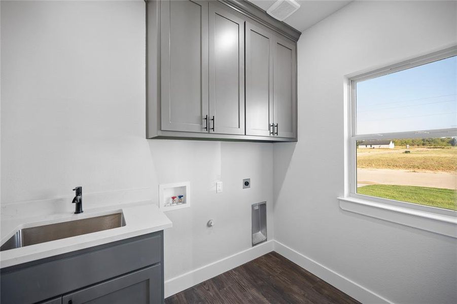 Laundry room with custom cabinets and utility sink with quartz countertops