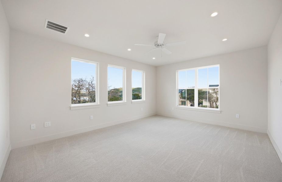 Oversized guest bedroom with views of Lake Travis