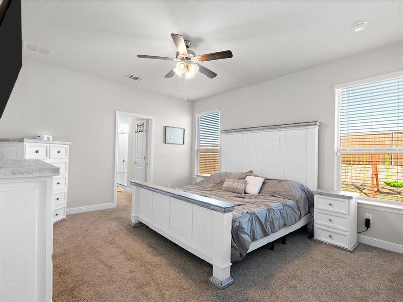 Carpeted bedroom featuring ceiling fan