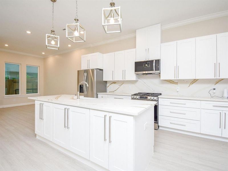 The kitchen opens to a huge covered patio, fully sodded and private backyard.