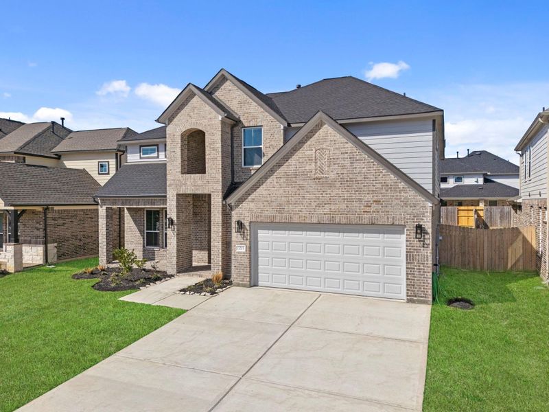 Front exterior of a new home in Barton Creek Ranch, Conroe, TX, highlighting curb appeal (Image 18).