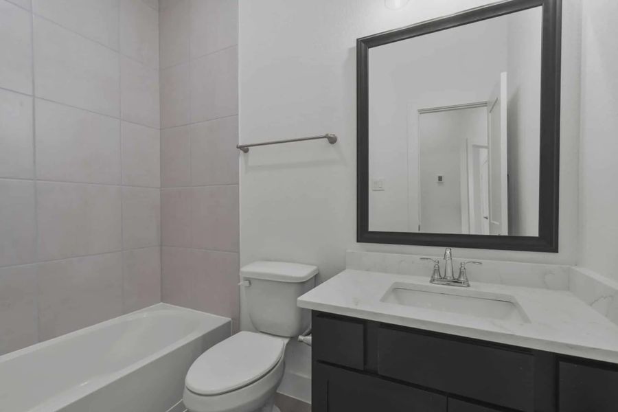 Representative furnished interior of a home built from the Carriagehouse by Chesmar Homes in Meridiana Townhomes, Iowa Colony (Image 58).