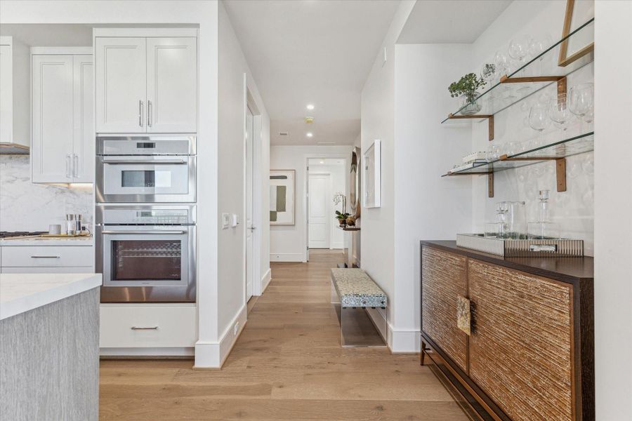 Looking into the entry hall from the interior. Photos are of a similar unit with the same floor plan