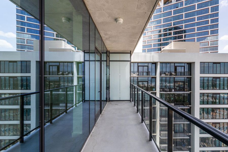A sleek modern balcony provides an elevated cityscape view, perfect for relaxation.