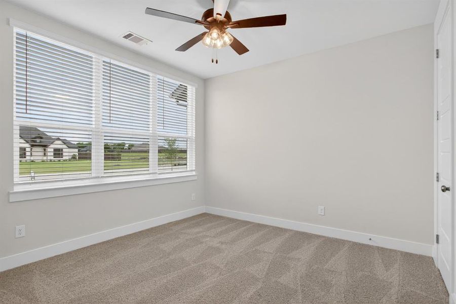 Expansive window with white blinds, neutral carpeting, and light-toned walls Expansive window with white blinds, neutral carpeting, and light-toned walls