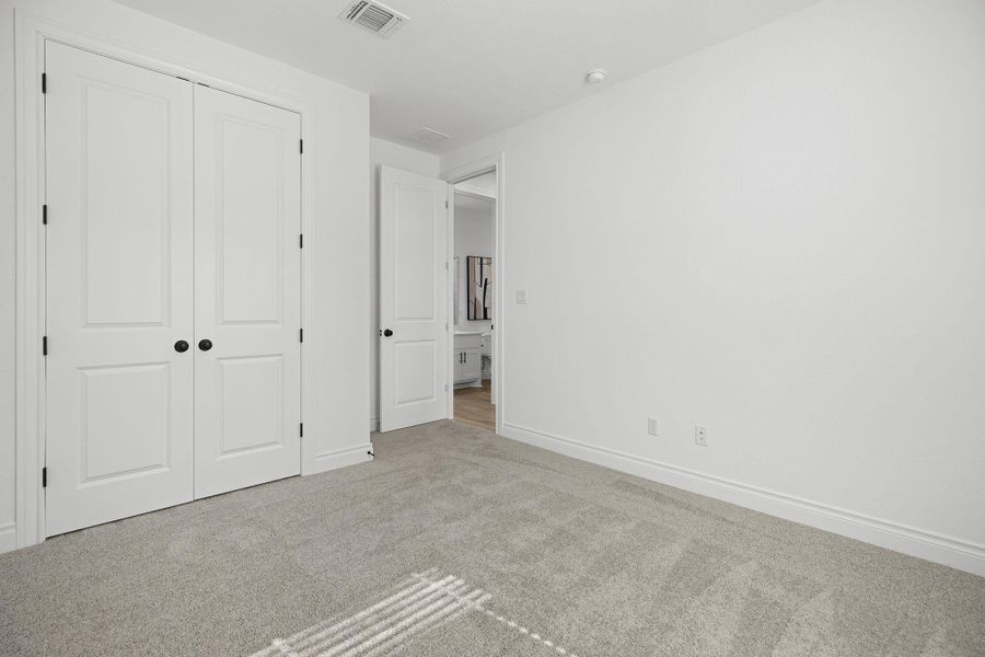 Unfurnished bedroom featuring carpet and a closet