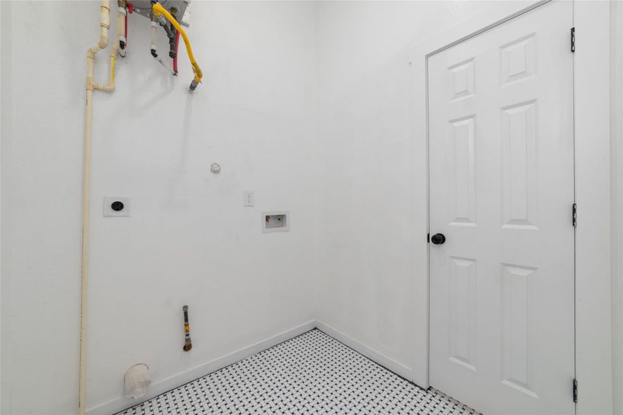Conveniently located interior laundry room designed for functionality and flexibility, with connections available for both gas and electric dryers. Conveniently located interior laundry room designed for functionality and flexibility, with connections available for both gas and electric dryers.