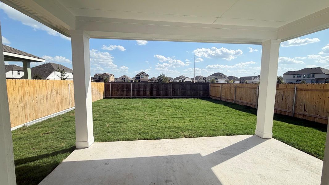 A spacious backyard with fresh green grass is enclosed by a privacy fence, perfect for outdoor activities. A spacious backyard with fresh green grass is enclosed by a privacy fence, perfect for outdoor activities.
