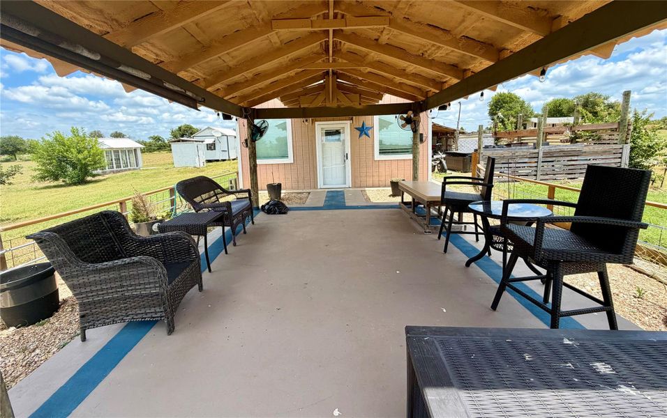 A spacious covered porch offers comfortable outdoor living with scenic views of the surrounding landscape.