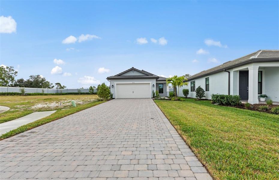 Front exterior of a new home in Arbor Oaks, North Port, FL, highlighting curb appeal (Image 18). Front exterior of a new home in Arbor Oaks, North Port, FL, highlighting curb appeal (Image 18).