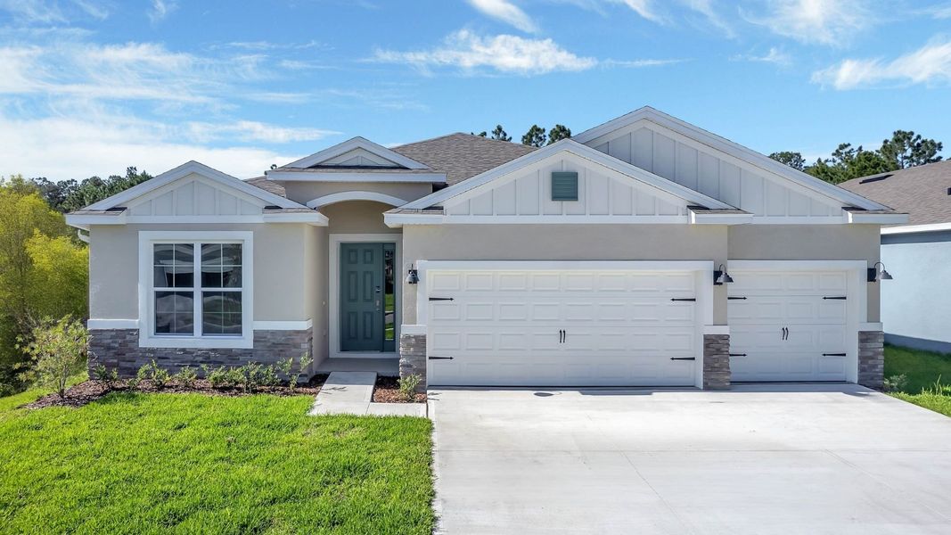 Front exterior of a new home in Archers Mill, Ormond Beach, FL, highlighting curb appeal (Image 1).