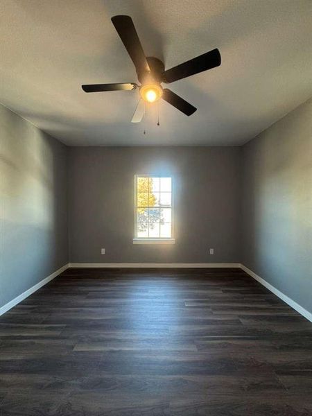 Spare room with dark wood-style floors and a textured ceiling