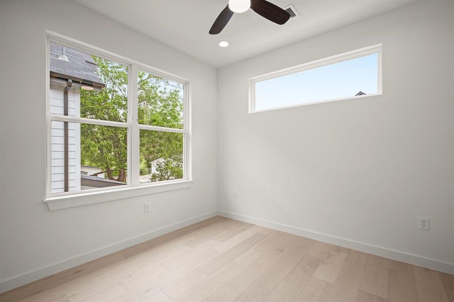 Spare room with light wood-style floors, ceiling fan, and recessed lighting