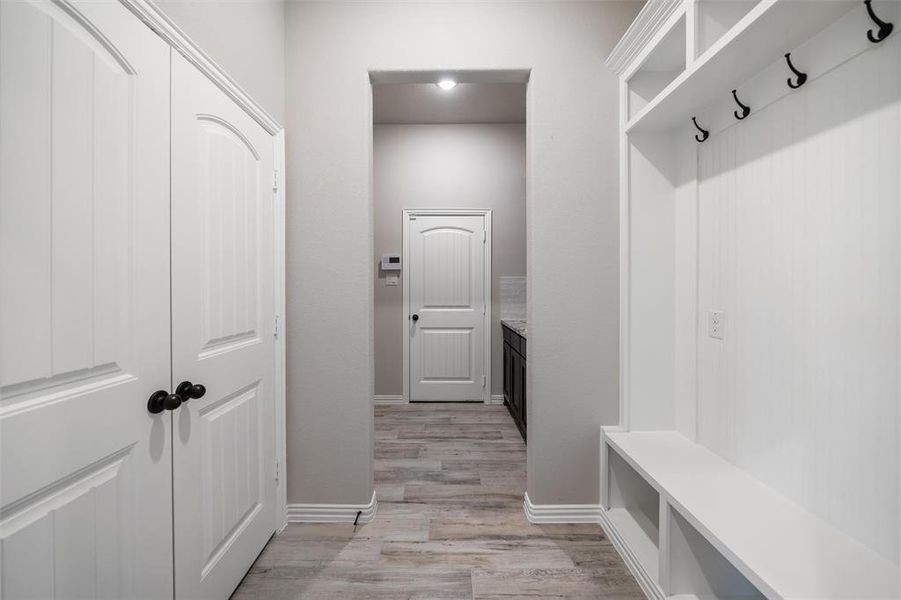 Mudroom with light wood-style flooring and baseboards Mudroom with light wood-style flooring and baseboards