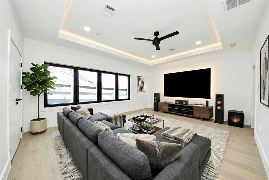 The media room is a sleek, private retreat, designed for cinematic experiences with plush seating, state-of-the-art audiovisual equipment, and elegant ambient lighting.