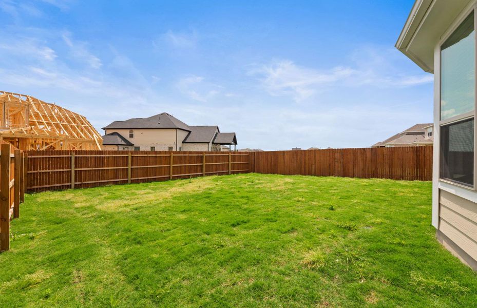 Front exterior of a new home in Santa Rita Ranch, Liberty Hill, TX, highlighting curb appeal (Image 18).
