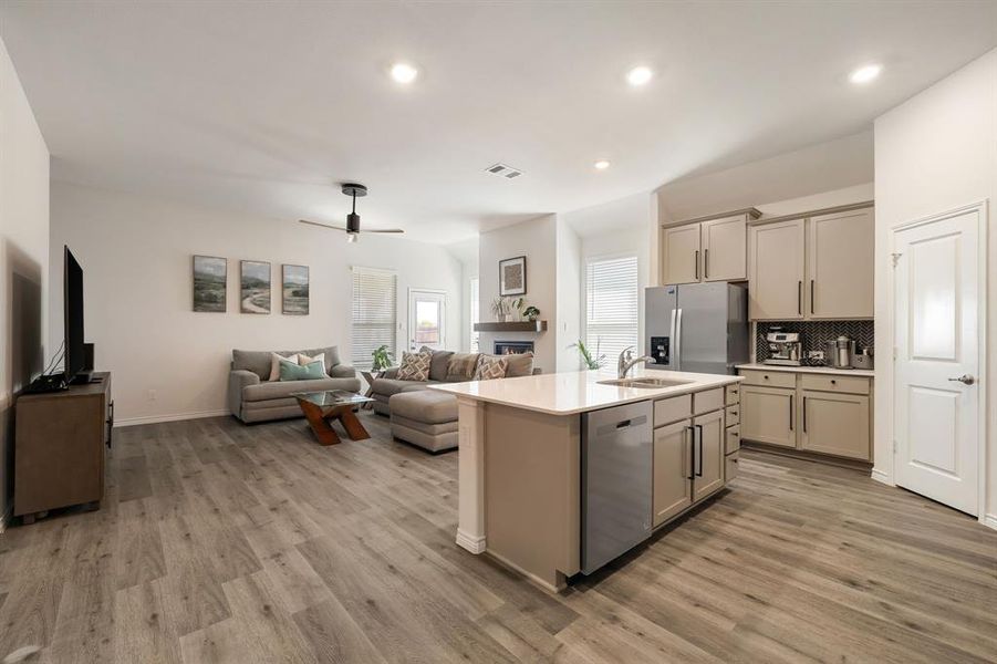 Kitchen with open floor plan, a kitchen island with sink, recessed lighting, decorative backsplash, and appliances with stainless steel finishes Kitchen with open floor plan, a kitchen island with sink, recessed lighting, decorative backsplash, and appliances with stainless steel finishes