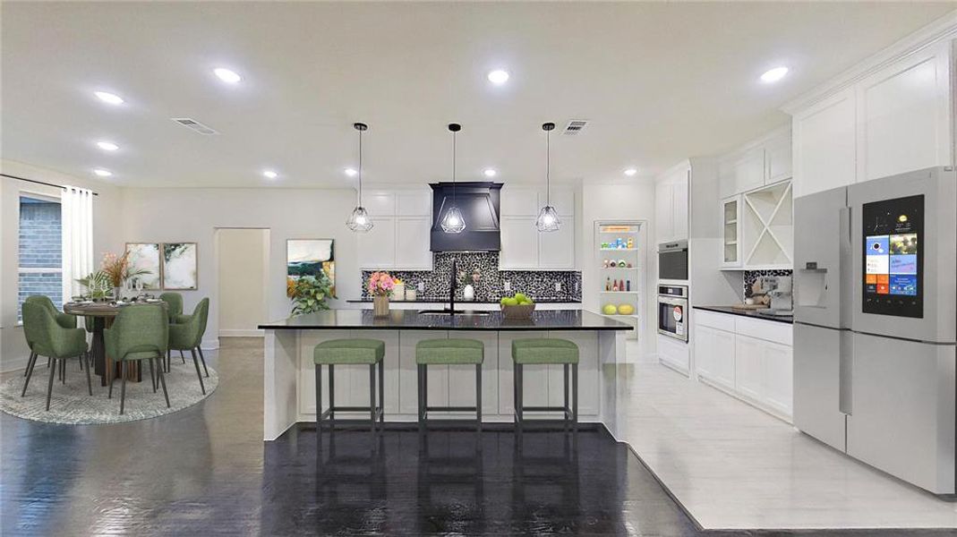 Kitchen with white fridge with ice dispenser, white cabinets, a kitchen bar, a large island, and pendant lighting Kitchen with white fridge with ice dispenser, white cabinets, a kitchen bar, a large island, and pendant lighting