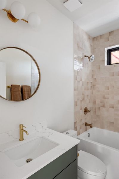 Bathroom featuring vanity and shower / bath combination Bathroom featuring vanity and shower / bath combination