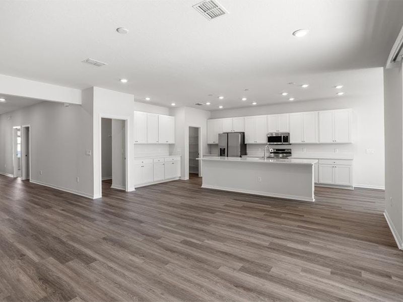 Enjoy a light-filled open living area - Everly by Highland Homes