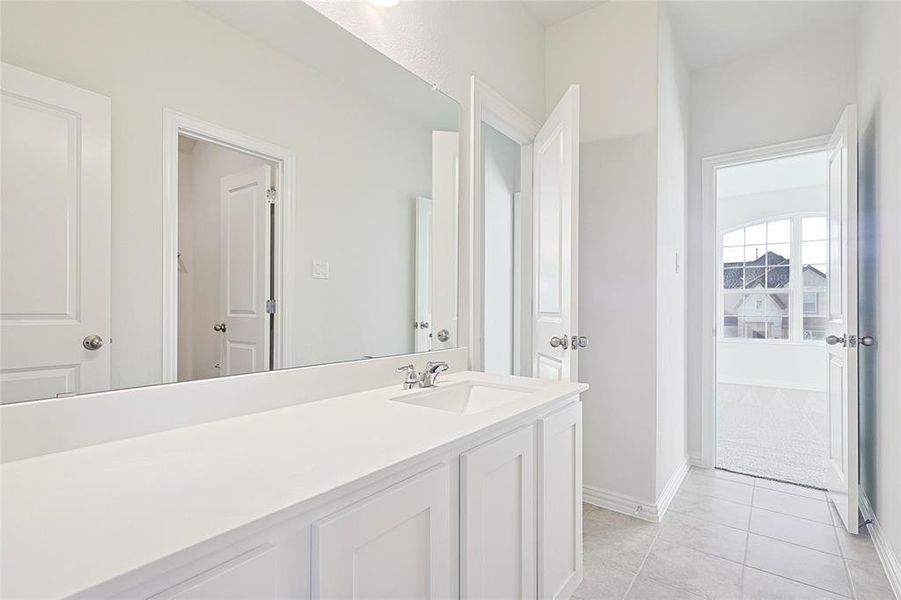 Bathroom featuring vanity and light tile patterned flooring Bathroom featuring vanity and light tile patterned flooring