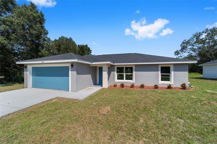 Front exterior of a new home in , Dunnellon, FL, highlighting curb appeal (Image 17).
