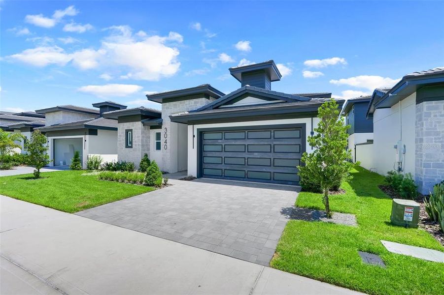 Front exterior of a new home in Hampton Green at Providence, Davenport, FL, highlighting curb appeal (Image 24).