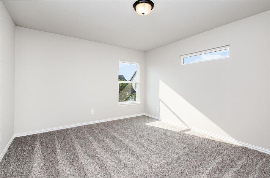 Empty room with carpet and healthy amount of natural light