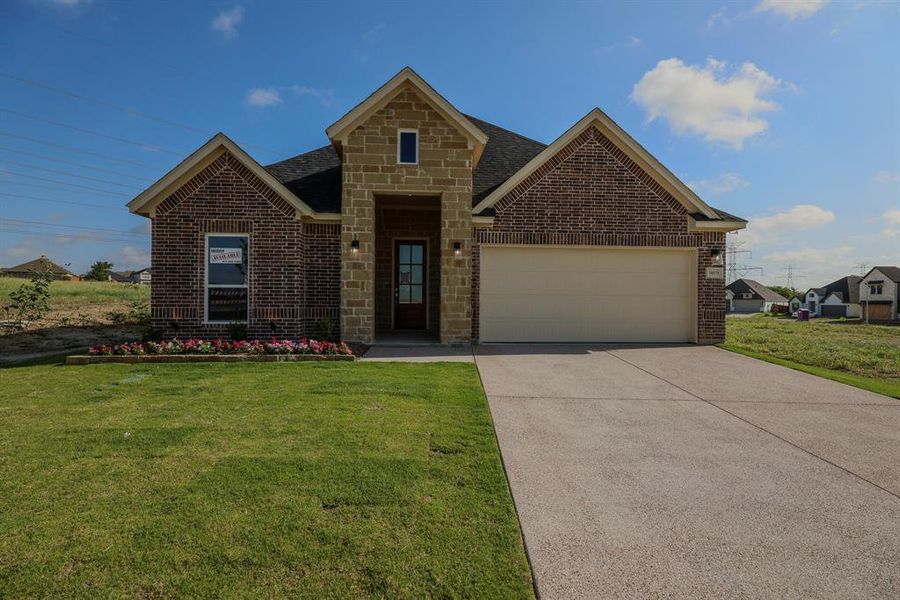 View of front of home featuring a garage, brick siding, concrete driveway, and a front lawn View of front of home featuring a garage, brick siding, concrete driveway, and a front lawn