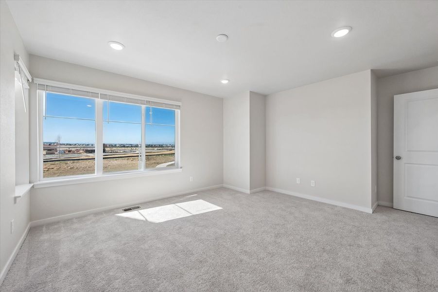 A room with a window and a rug in it.